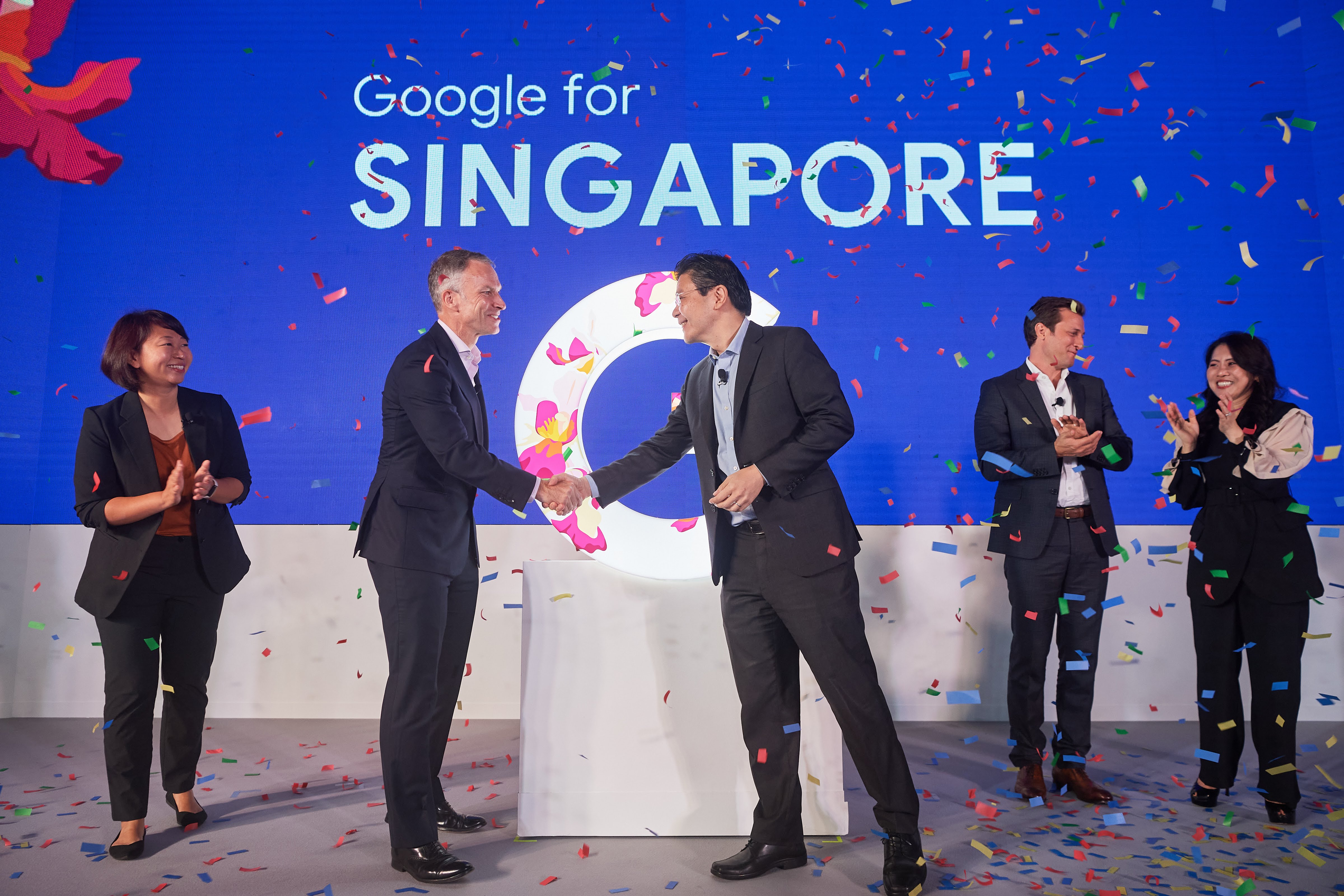 Corporate launch ceremony with confetti and branded stage backdrop